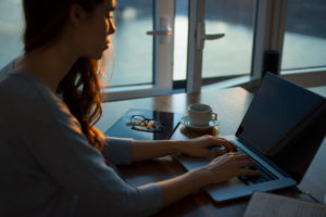 Girl in front of window with computer